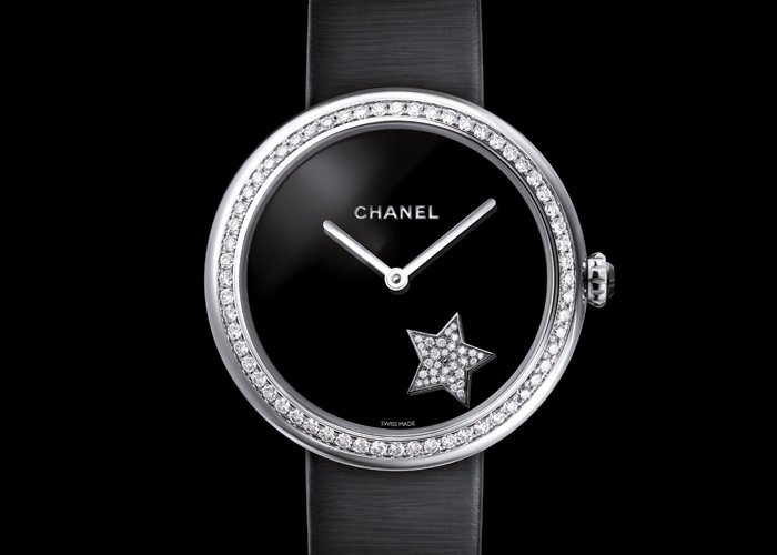 18K white gold and diamond case. Black dial with rotating diamond-set motif. Self-winding Chanel12-WS mechanical movement. 42-hour power reserve. Black satin bracelet with diamond-set ardillon buckle. Diameter: 37.5 mm.