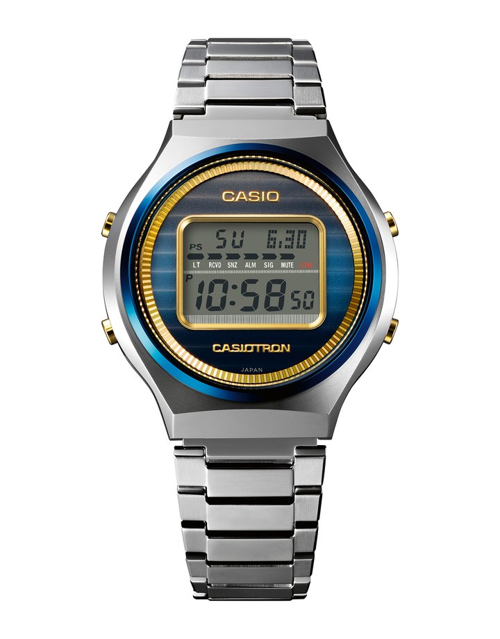 The Casio Watch 50th Anniversary Casiotron TRN-50SS. The re-created dial features a blue fluted pattern and gold accents to evoke the sky, the sea and sunlight. The screw-lock case back is embellished with the 50th Anniversary logo in a gold tone. The 50th Anniversary lettering reappears on the mirror-polished bicolour bracelet.