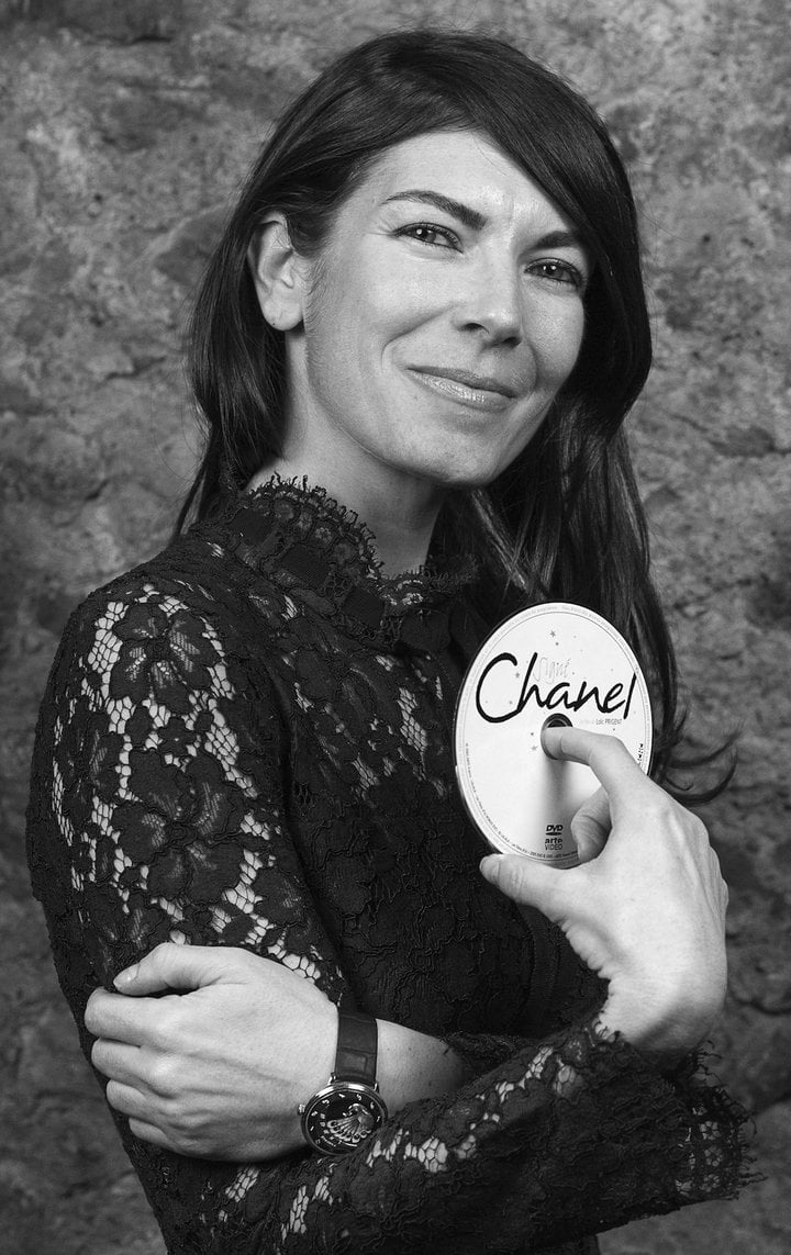 Aurélie Picaud, photographed by Fabien Fabien Scotti at the Arcade Europa Star, holding the DVD of the documentary film Signé Chanel by Loïc Prigent, released in 2013, that follows the production of a Chanel Haute Couture collection from A to Z. “I have always been fascinated by Gabrielle Chanel and her whole story. I love her sharp character and avant-garde choices, the way she laid claim to menswear codes to revolutionise the way that women dress, liberating them from constraints and corsets. She is a role model for me. And I admire the brand's strict continuity, timelessness and chic elegance, and how it always manages to include a hint of rock n' roll. And intransigence, besides!”