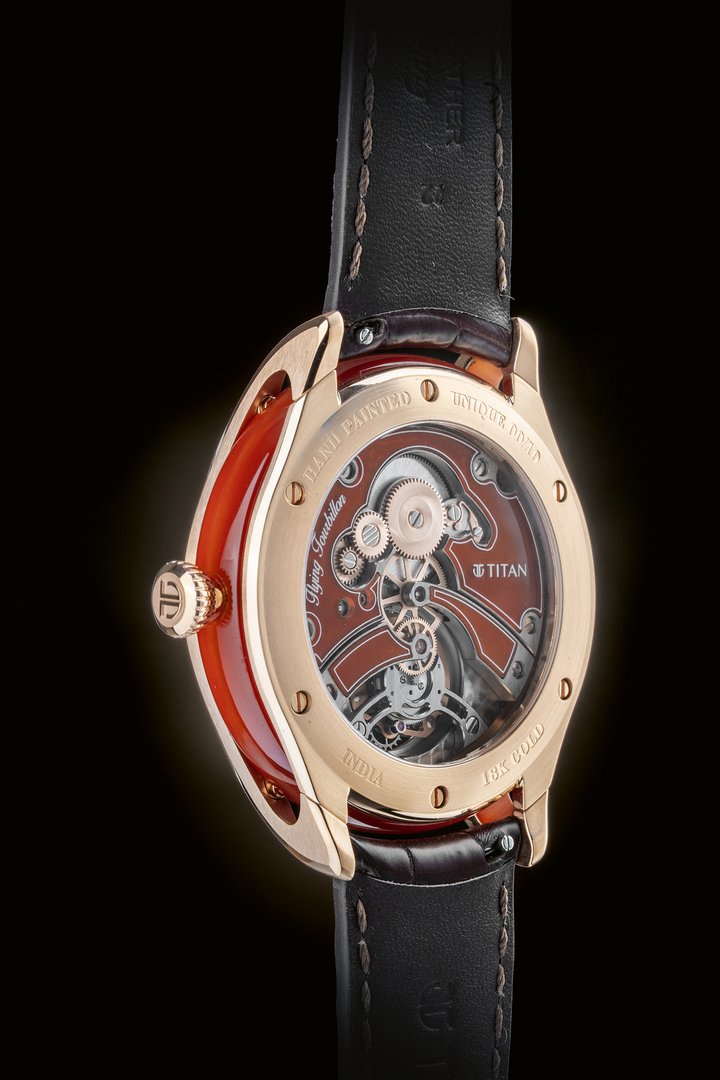 The movement architecture references Jaipur's architectural lines, with bridges set in natural red agate. The movement itself showcases nine distinct finishes, including circular Côtes de Genève with chamfering and circular graining, and circular satin-finishing with chamfering. A sapphire crystal caseback reveals the fully decorated movement.